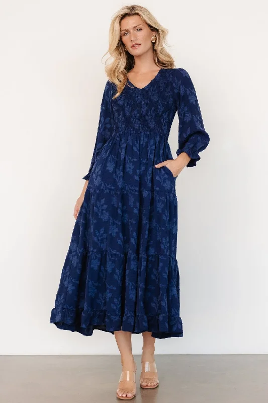 Midi dresses with geometric cutouts for a contemporary and edgy look Aubrey Smocked Midi Dress | Navy Floral Midi dresses with geometric cutouts for a contemporary and edgy look Aubrey Smocked Midi Dress | Navy Floral